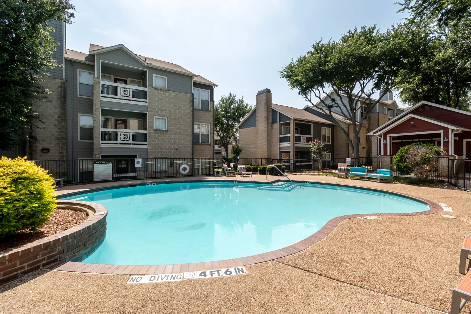 Swimming pool surrounded by apartment homes at Western Station at Fossil Creek in Fort Worth, Texas